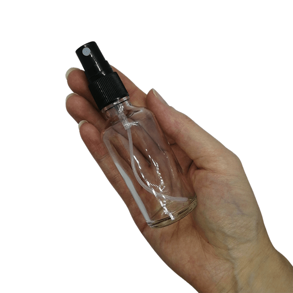 50ml clear glass bottle with black mister spray in hand 2